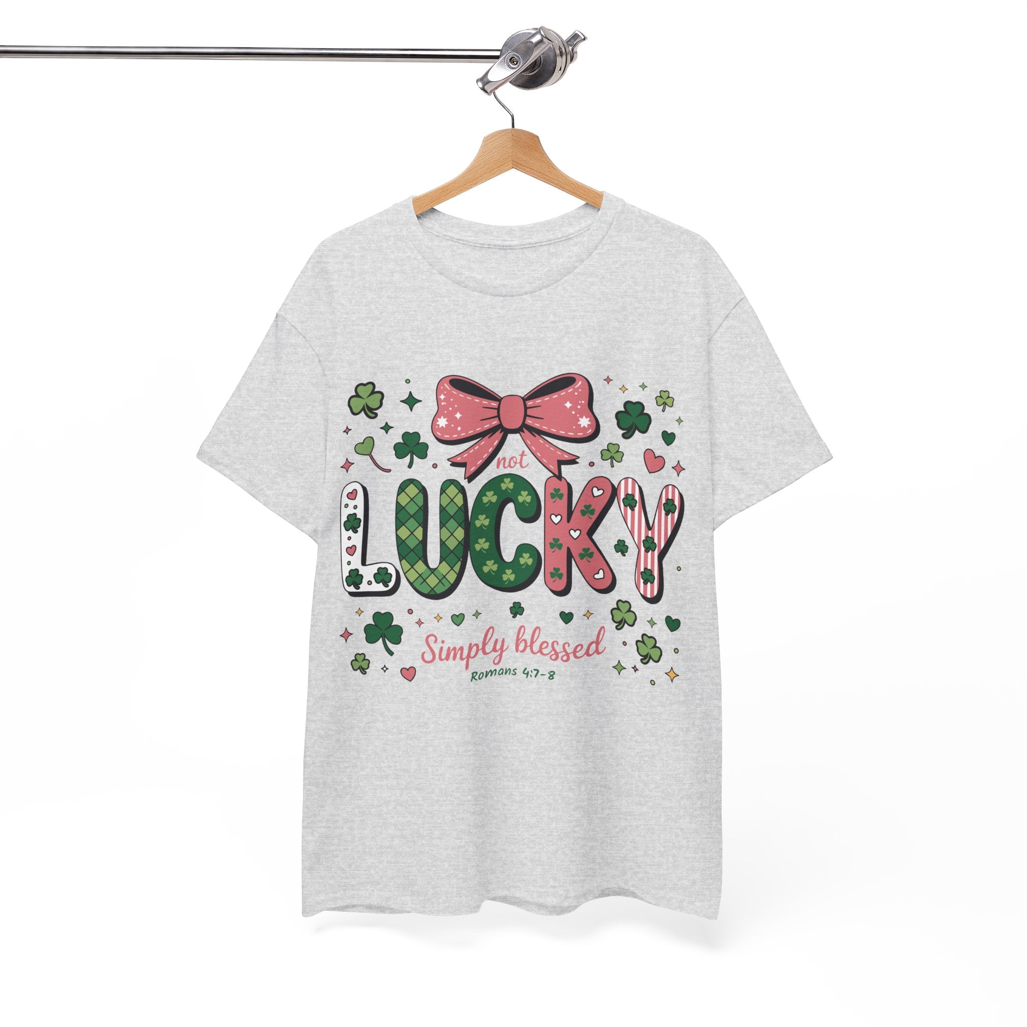Simply Blessed Tee — “Not Lucky, Simply Blessed” with Pastel Bow, Clovers & Romans 4:7-8 Unisex Cotton Tee