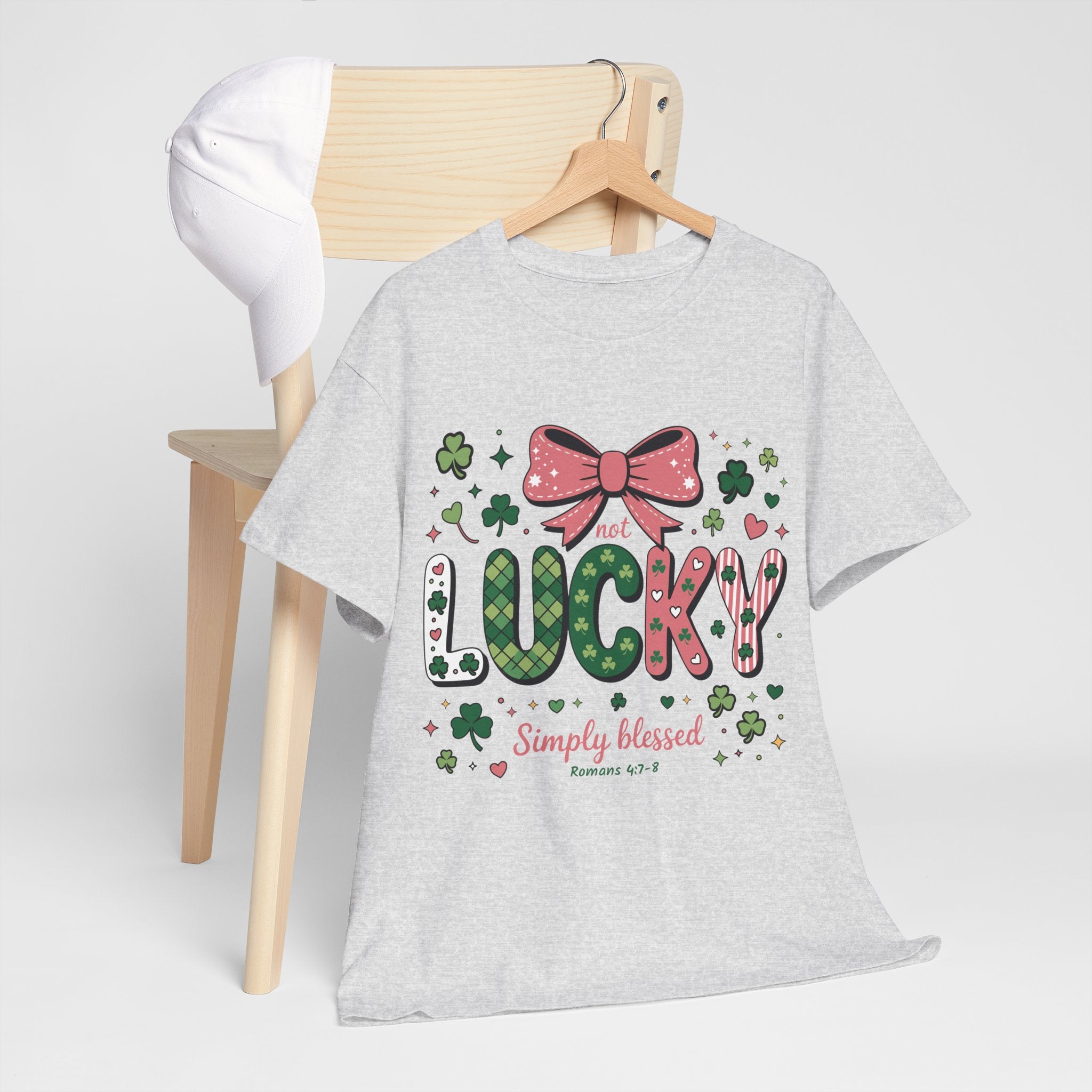 Simply Blessed Tee — “Not Lucky, Simply Blessed” with Pastel Bow, Clovers & Romans 4:7-8 Unisex Cotton Tee