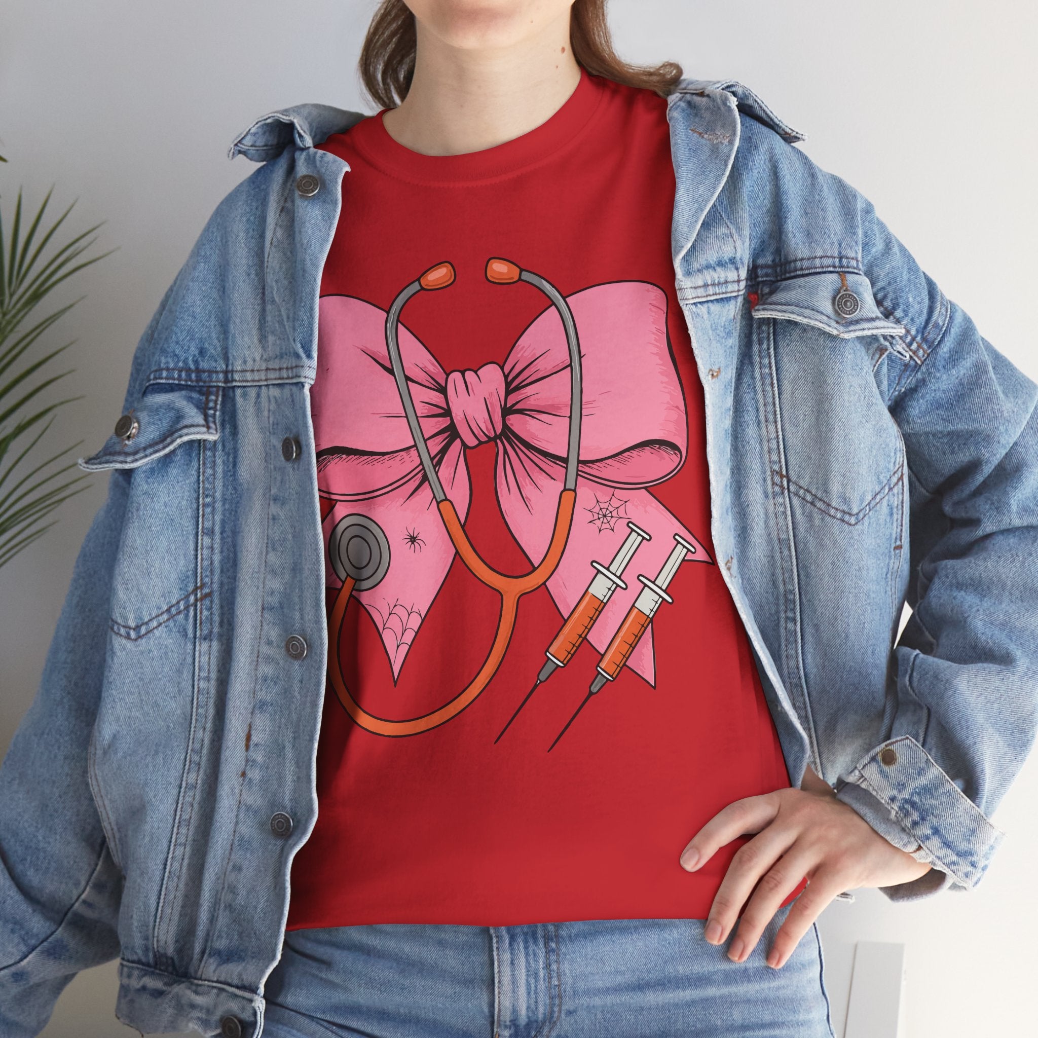 Halloween Nurse T‑Shirt — Pink Nurse Bow with Stethoscope, Syringes & Spider Webs..Unisex Cotton Tee