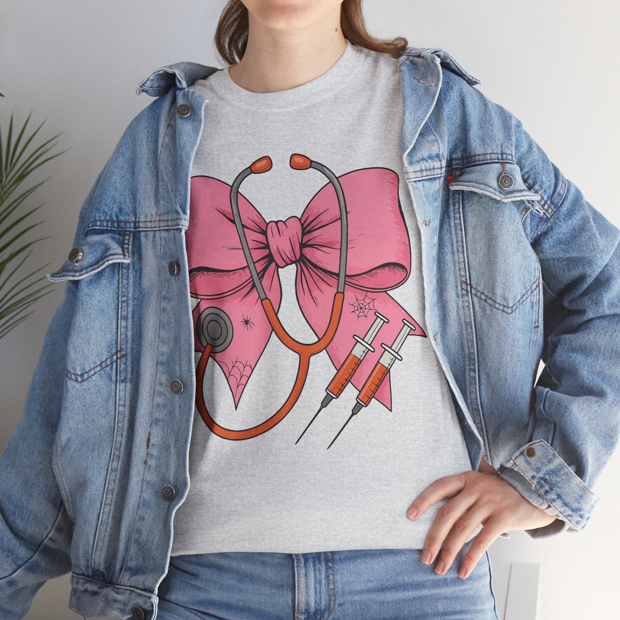 Halloween Nurse T‑Shirt — Pink Nurse Bow with Stethoscope, Syringes & Spider Webs..Unisex Cotton Tee