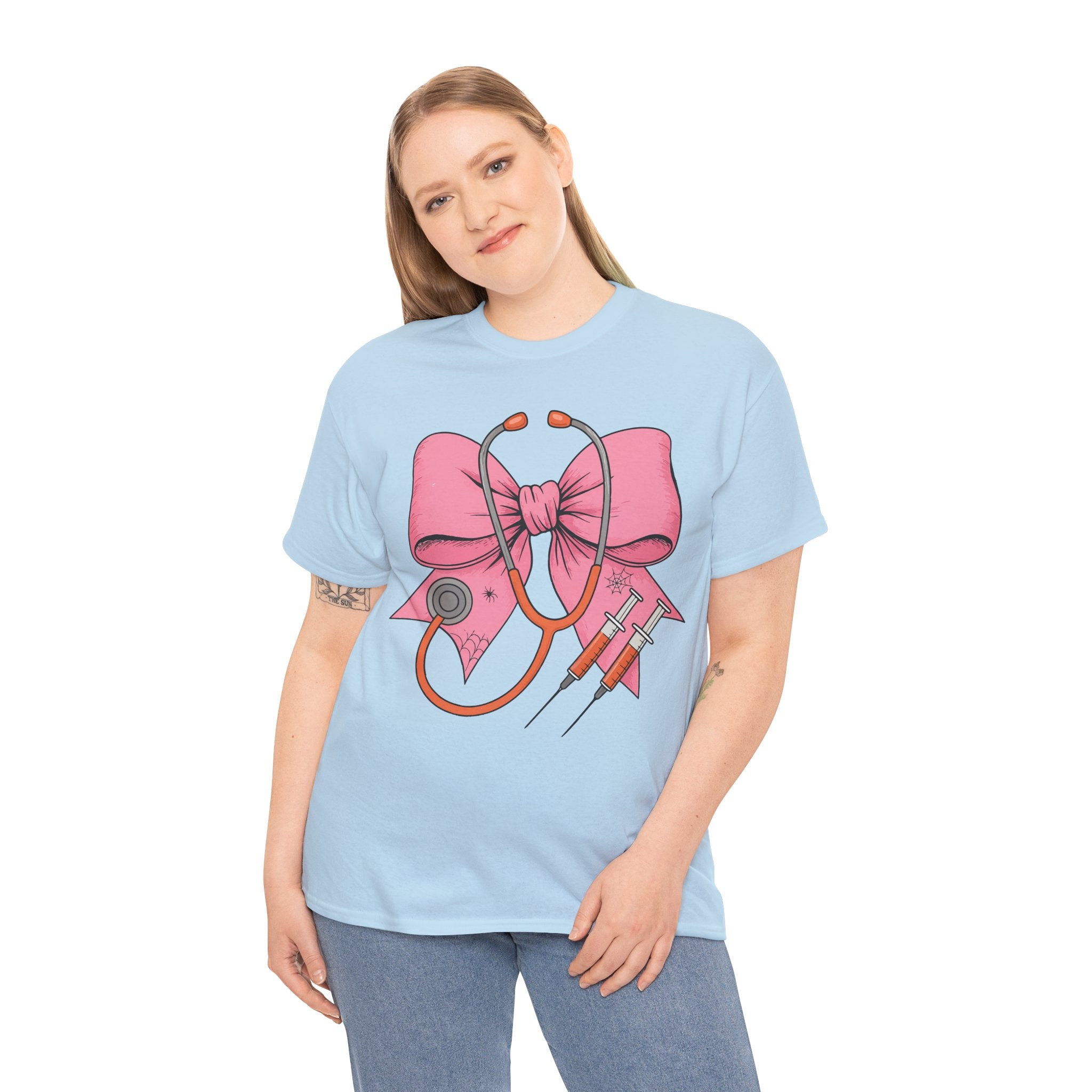 Halloween Nurse T‑Shirt — Pink Nurse Bow with Stethoscope, Syringes & Spider Webs..Unisex Cotton Tee