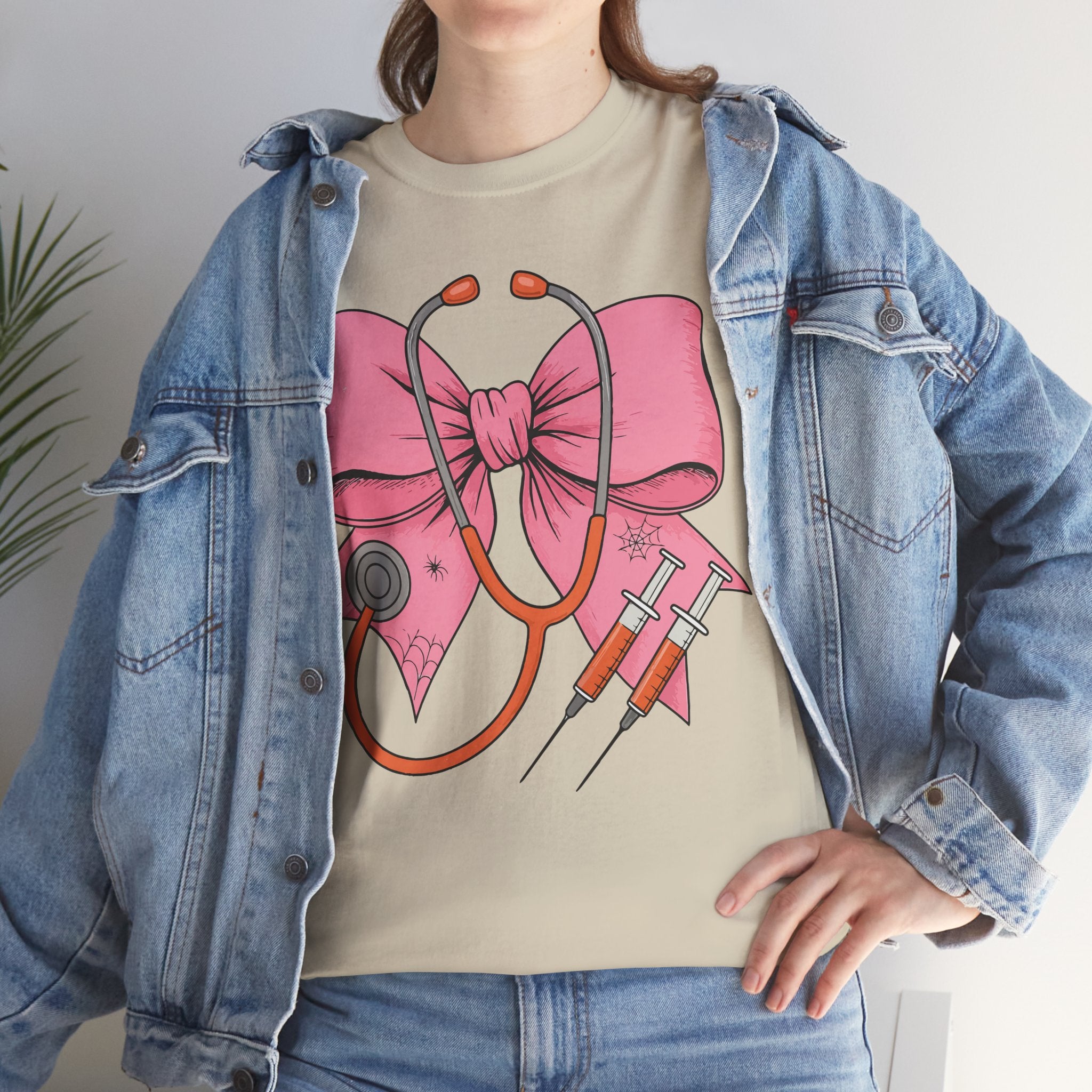 Halloween Nurse T‑Shirt — Pink Nurse Bow with Stethoscope, Syringes & Spider Webs..Unisex Cotton Tee