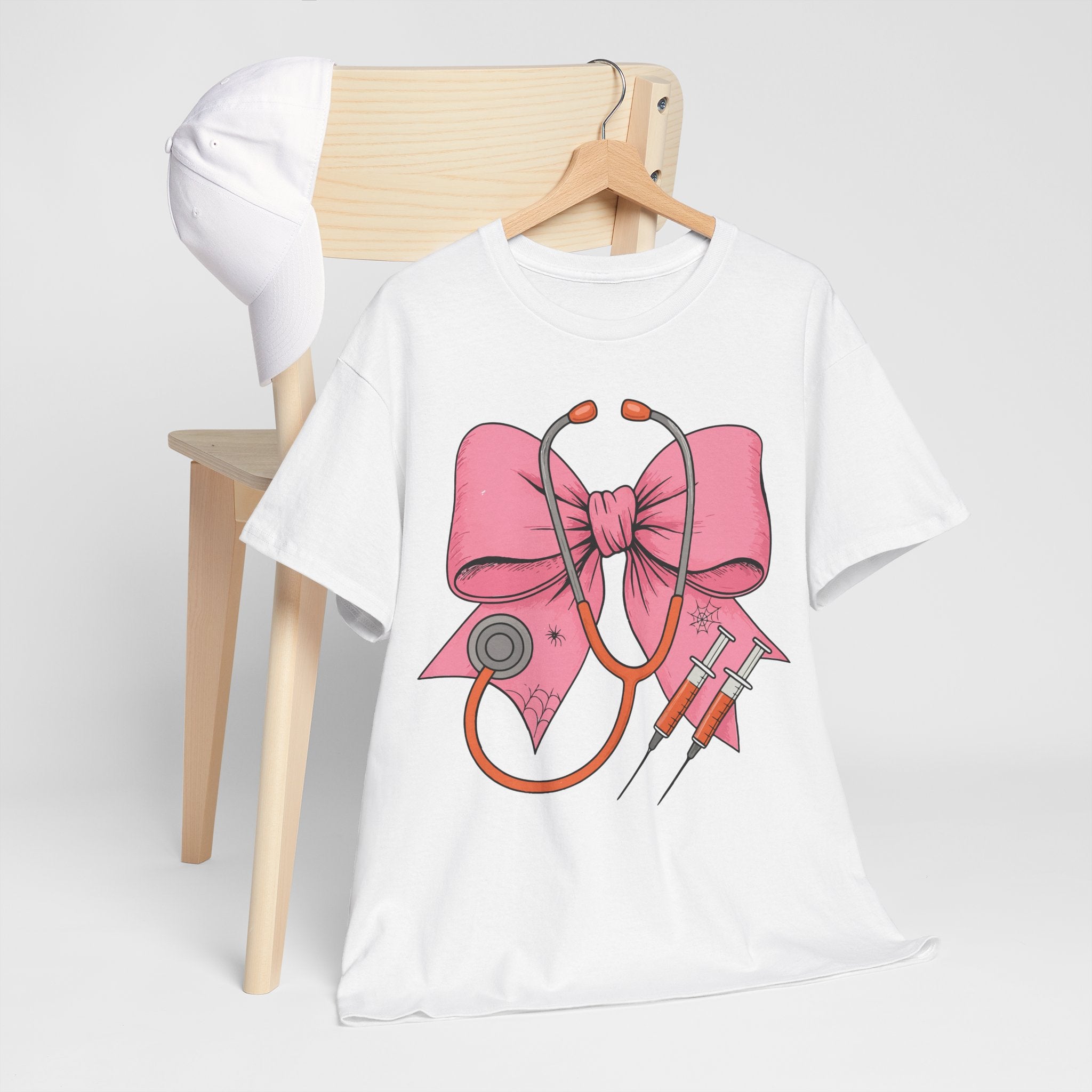 Halloween Nurse T‑Shirt — Pink Nurse Bow with Stethoscope, Syringes & Spider Webs..Unisex Cotton Tee