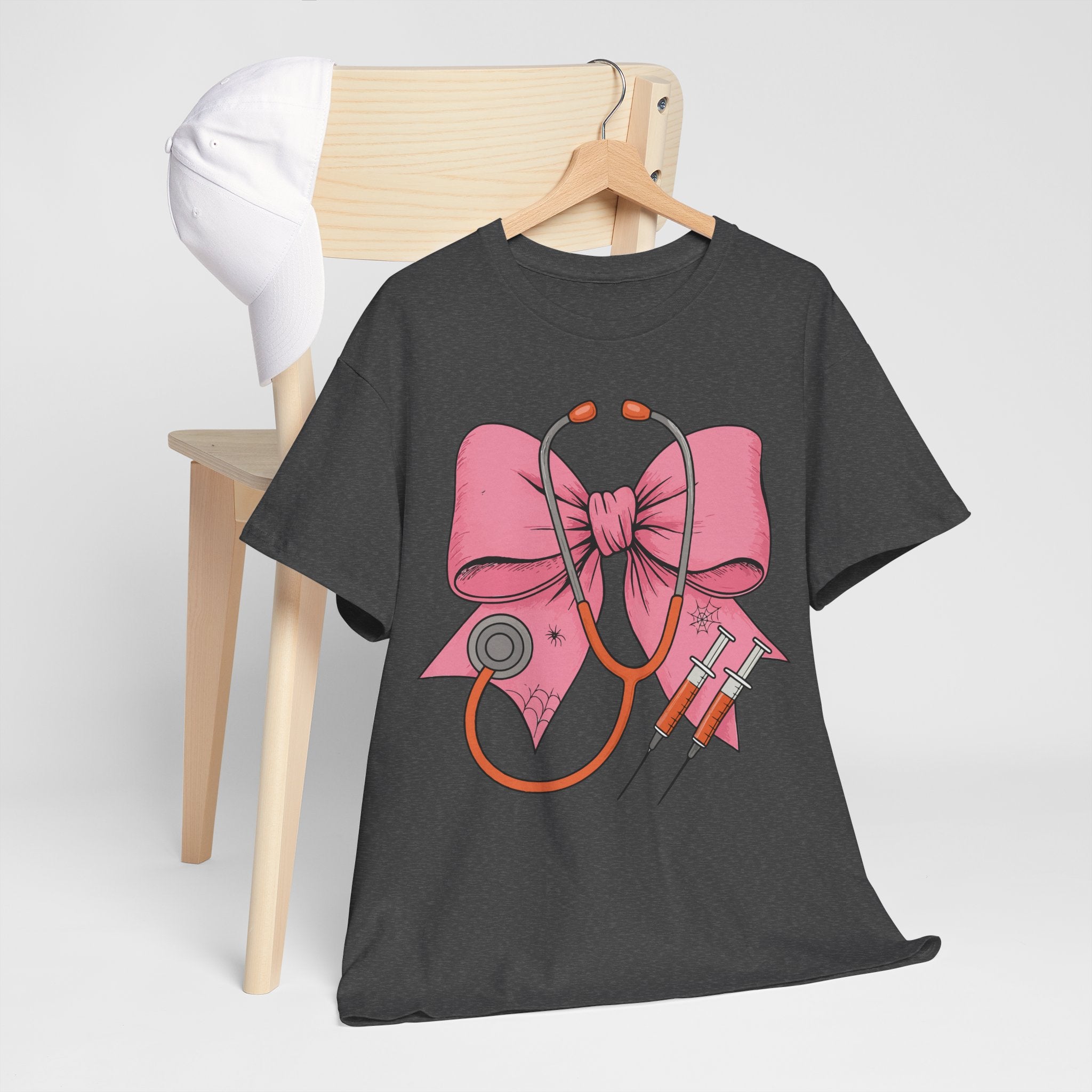 Halloween Nurse T‑Shirt — Pink Nurse Bow with Stethoscope, Syringes & Spider Webs..Unisex Cotton Tee