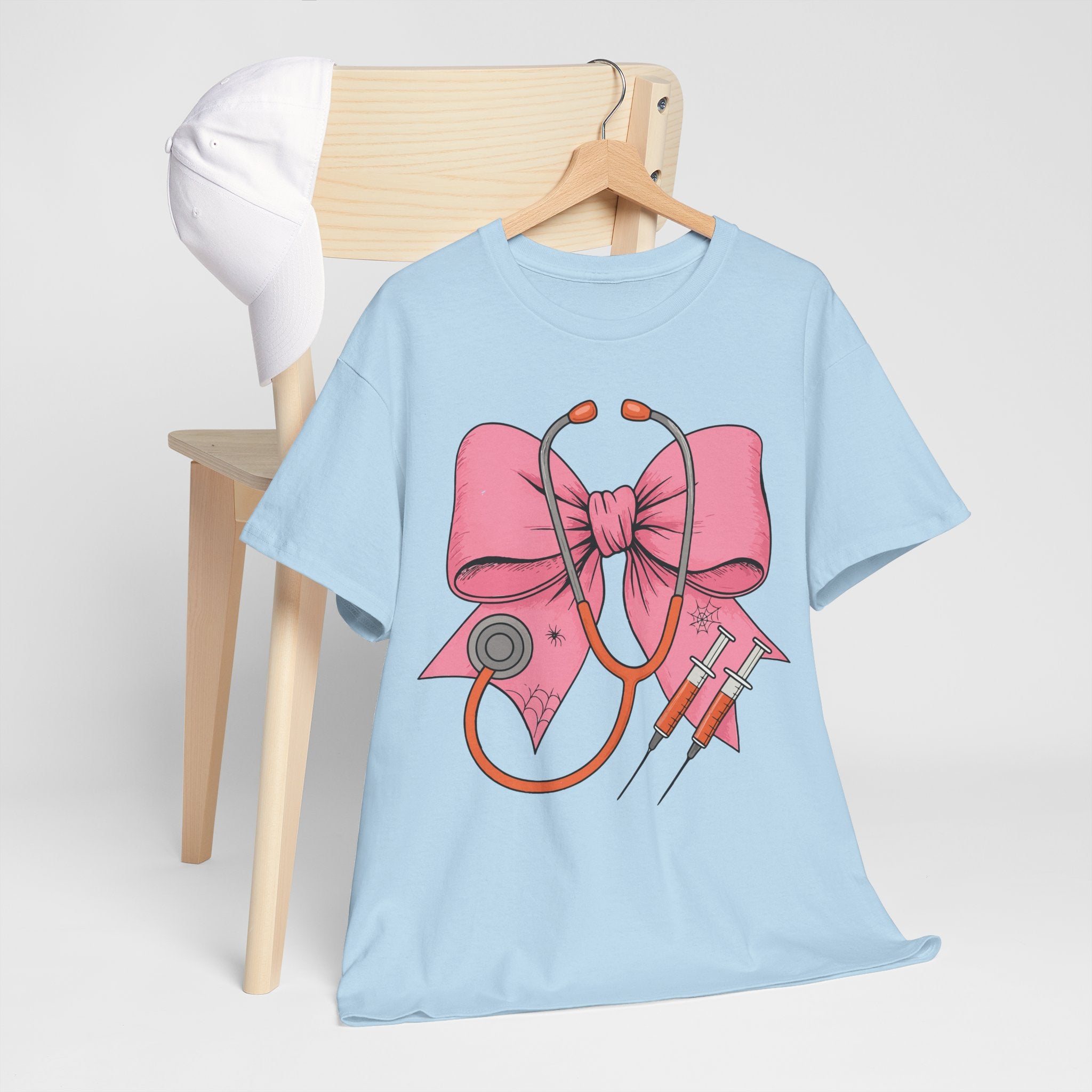 Halloween Nurse T‑Shirt — Pink Nurse Bow with Stethoscope, Syringes & Spider Webs..Unisex Cotton Tee